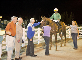 Wouf de Douf gets a pat from owner Bob Nokes after winning 7th race on Wednesday.