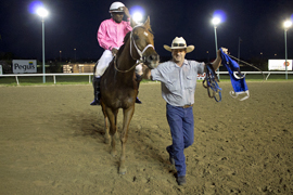 Trainer Jim Compton leads Cat's Classy Rider into the Winner's Circle.