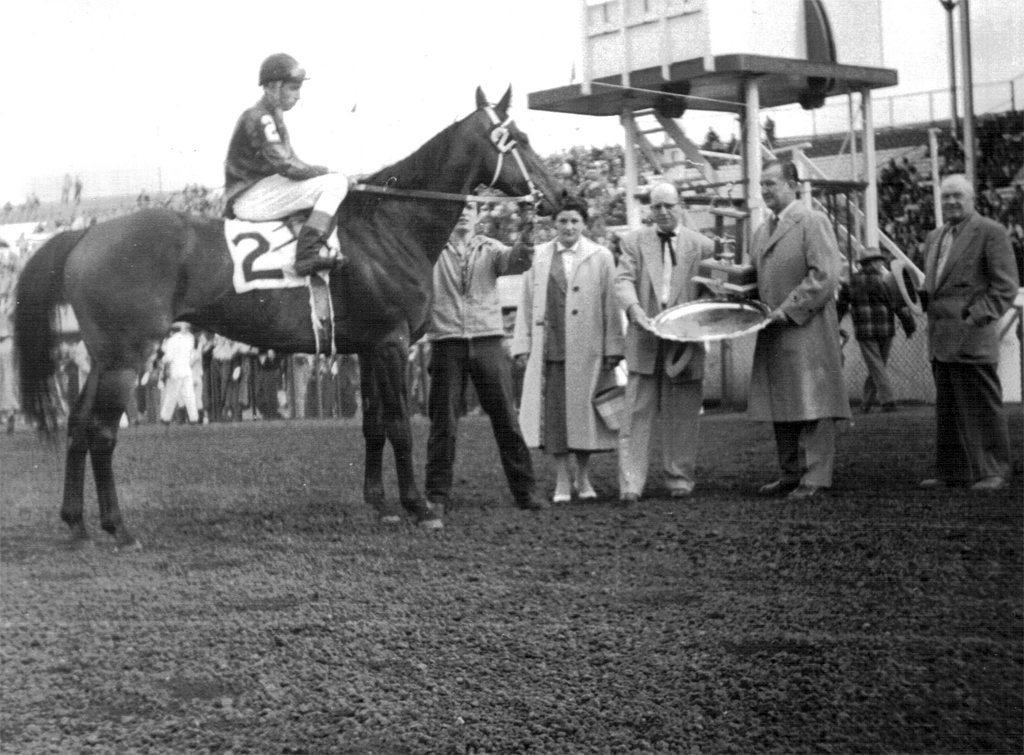 Light Dust wins Tweeworth Plate on June 15, 1957. Trainer Bob Watt accepts trophy platter for his favourite horse.