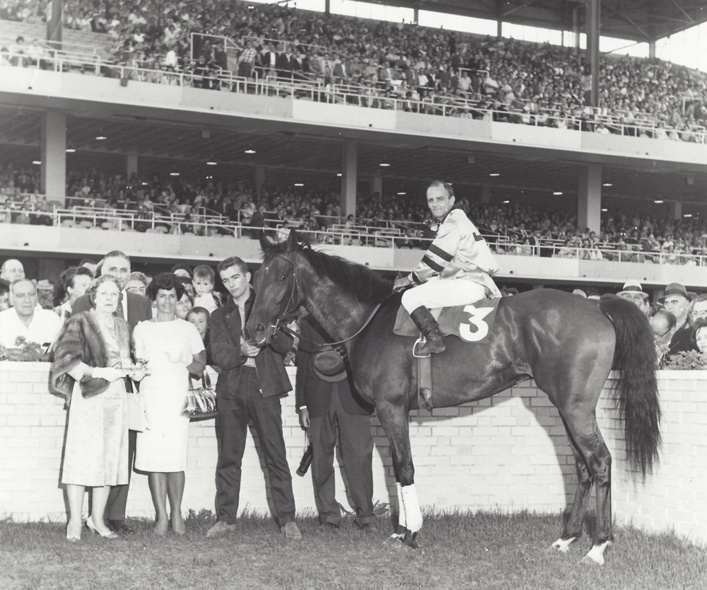 Bocage wins Manitoban Handicap at ASD. July 28, 1962. Tommy Stadnyk up. Mrs. Jack Hardy on the right. Mrs. John McDiarmid, wife of former Lieutenant Governor of Manitoba, on left.