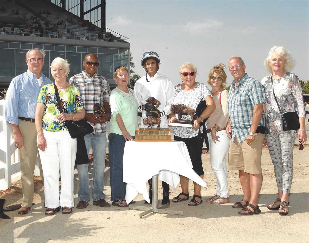 Bob Crocket (second from right) with friends and ownership partners, after winning a stakes race.
